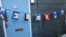 Load image into Gallery viewer, Nautical bunting with letters spelling out the word welcome.
