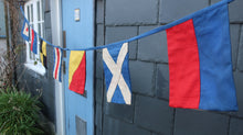 Load image into Gallery viewer, Reverse side of the welcome bunting showing the nautical signal flag
