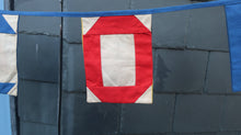 Load image into Gallery viewer, Flag showing the letter O from the Welcome bunting
