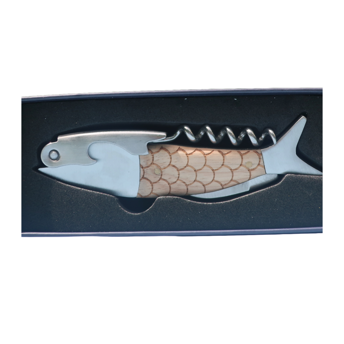 The fish bottle opener shown in it's display box. The bottle opener is shaped as a fish, with scales etched on to the wooden body of the fish or opener. It includes a bottle opener, a corkscrew and a small knife. A very poular gift.