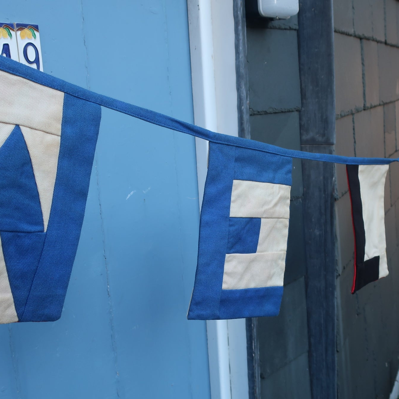 Nautical style bunting spelling out the word Welcome.