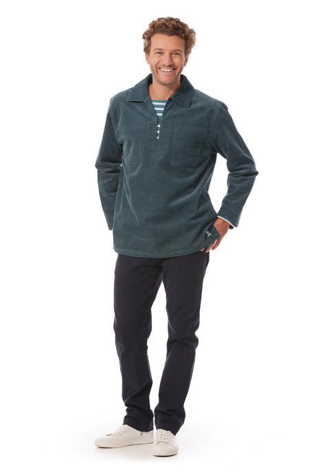 The Cachouroy is a fine corduroy version of the  traditional Breton Fisherman's smock. Shown here in a petrol blue colour. The top has a v neck and collar with a single fastening and two inside breast pockets.